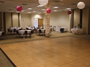 Image of dance floor in conference room with tables in background.